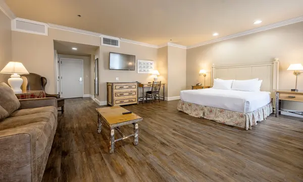 Hotel suite with a sitting area, sofa and king-size bed
