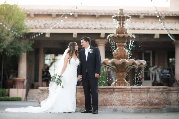 Newly married couple by fountain