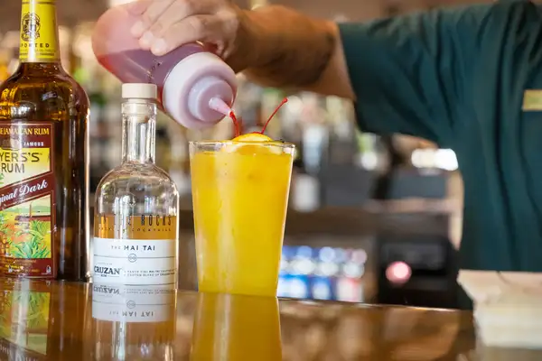 Bartender pouring a cocktail at the Horseshoe Lounge
