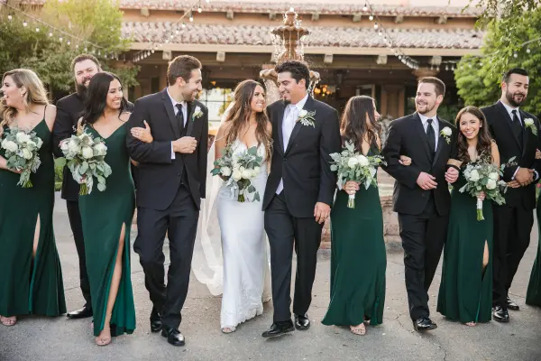 Wedding party in green dresses and black suits at Harris Ranch Resort