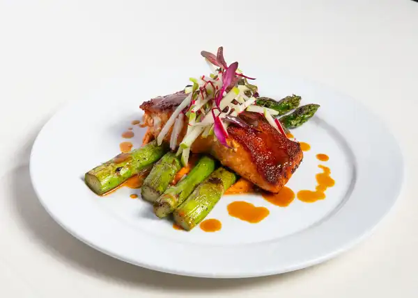 Prime Steakhouse glazed salmon over asparagus